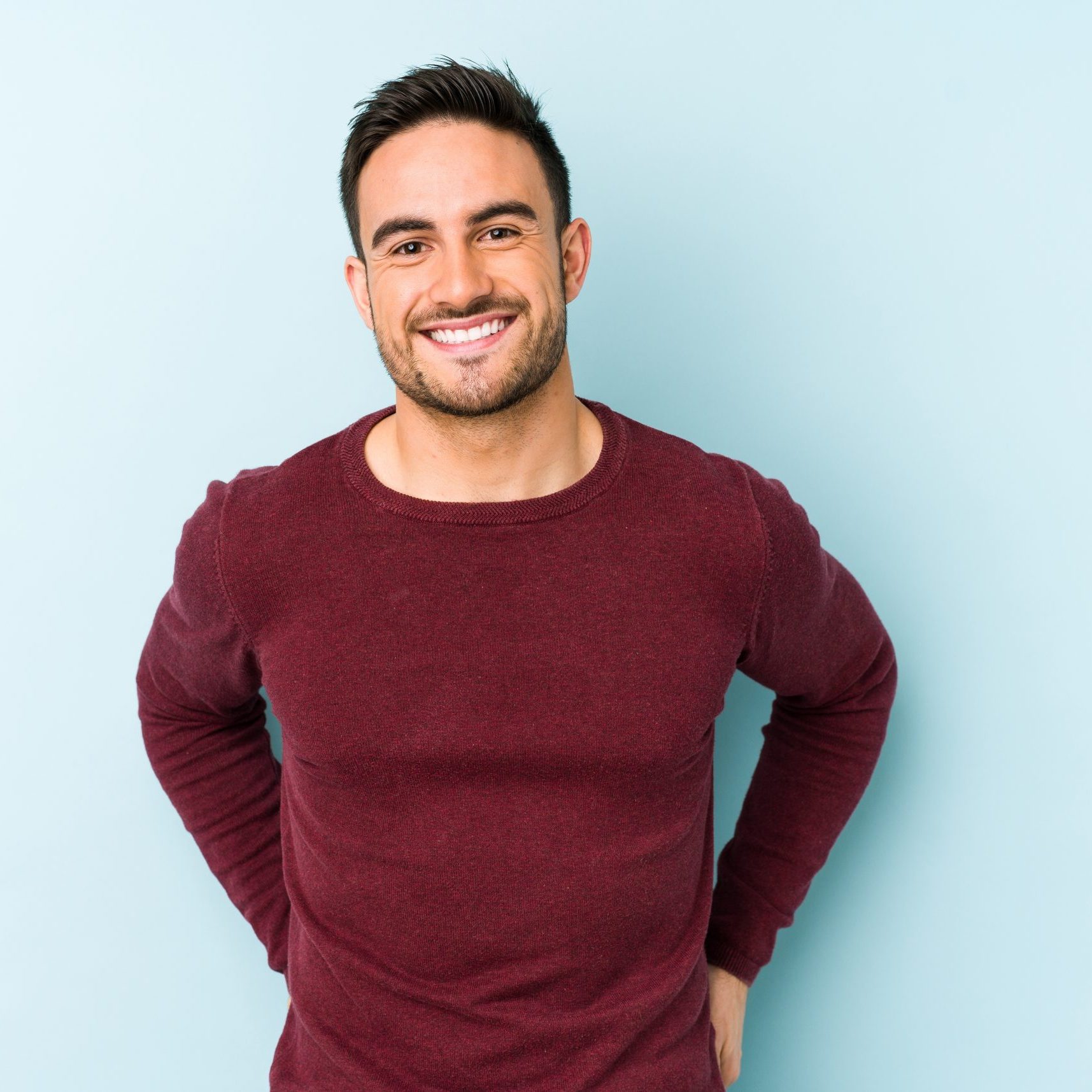 Young caucasian man isolated on blue background happy, smiling and cheerful.